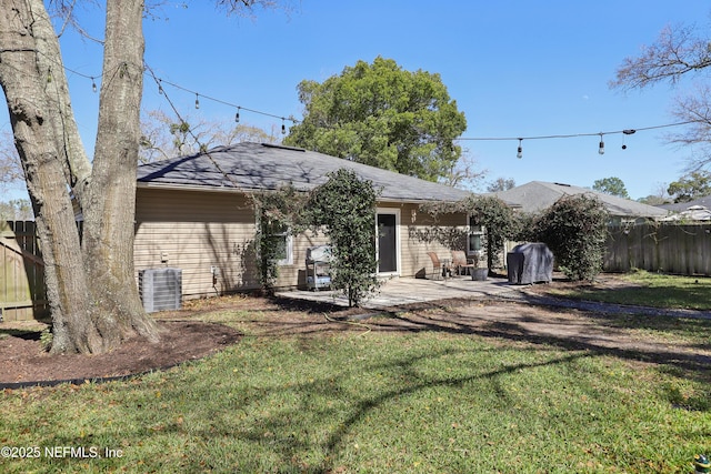 back of property with a patio area, central AC unit, fence, and a lawn