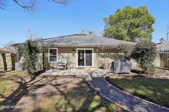 back of property featuring a patio and fence