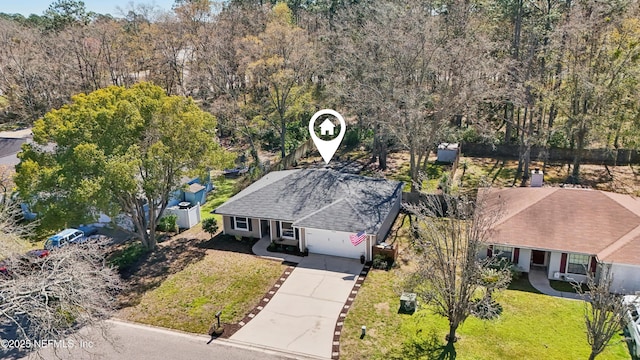 drone / aerial view featuring a wooded view