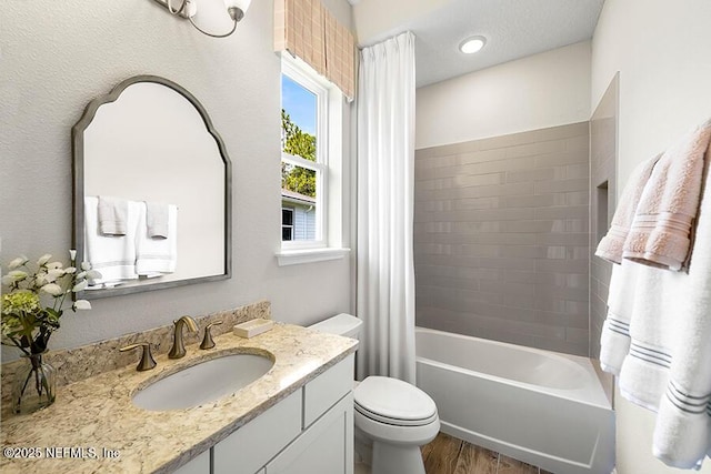 full bath featuring shower / bath combo with shower curtain, toilet, wood finished floors, and vanity