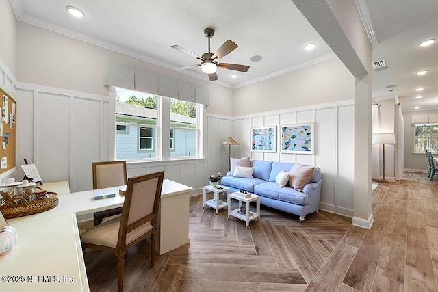 office featuring crown molding, a decorative wall, and a healthy amount of sunlight