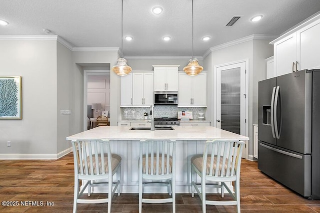 kitchen featuring a breakfast bar area, dark wood-style floors, visible vents, appliances with stainless steel finishes, and backsplash