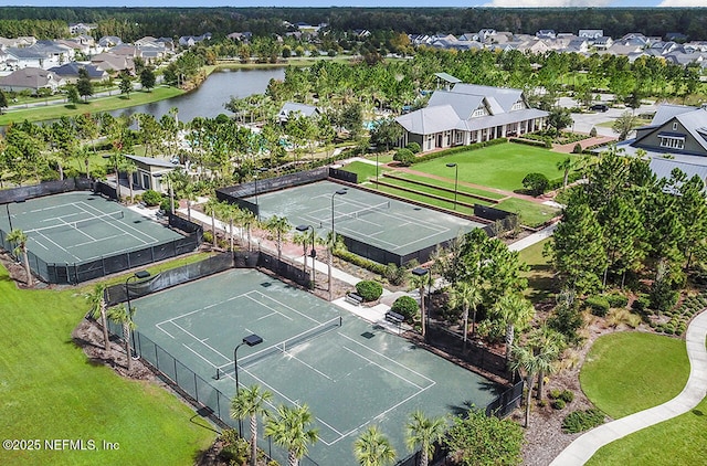 drone / aerial view featuring a residential view and a water view