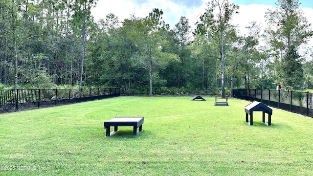 view of home's community featuring a yard and fence