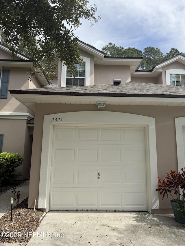 garage featuring concrete driveway