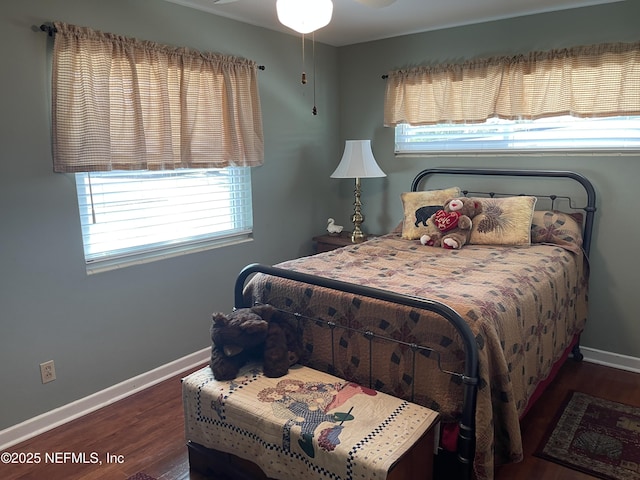 bedroom featuring baseboards and wood finished floors