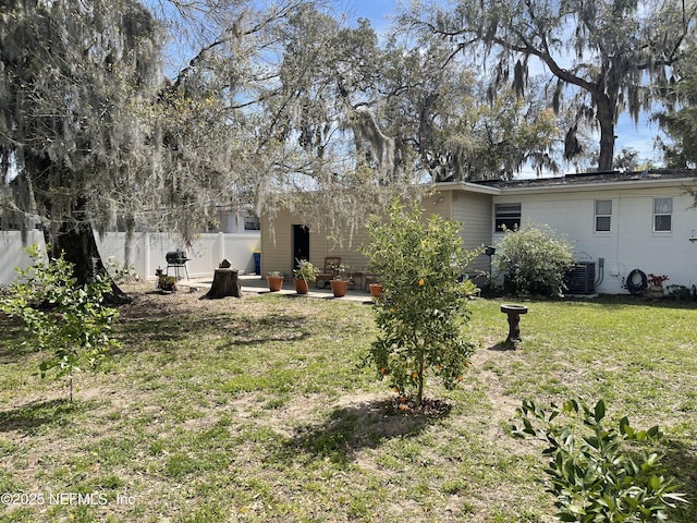 view of yard featuring central AC, fence private yard, and a patio area