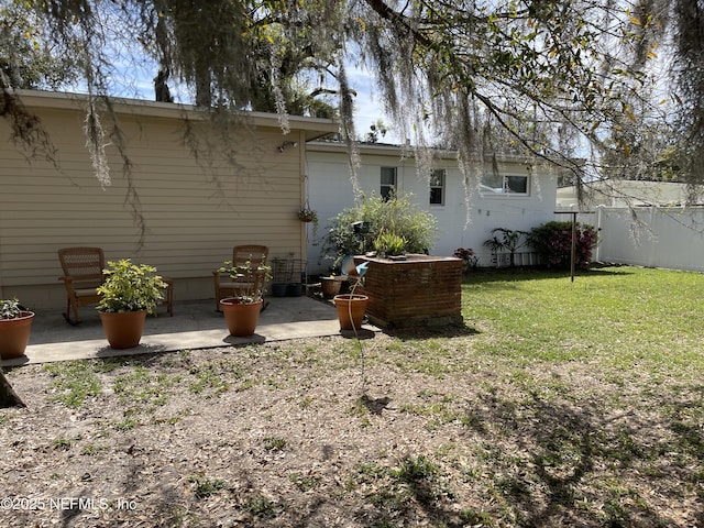 back of house with a yard, a patio, and fence