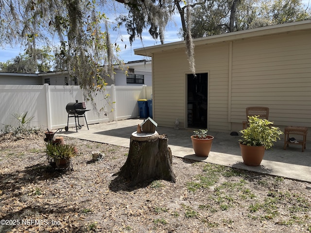 view of yard featuring fence and a patio area