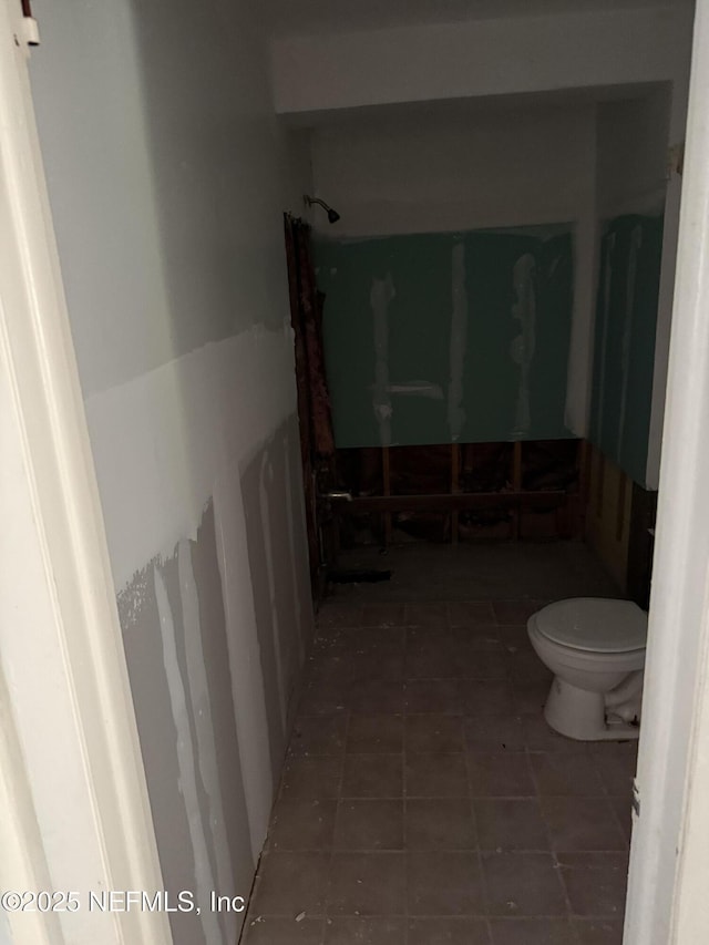 full bath with walk in shower, toilet, and tile patterned floors