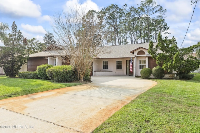 single story home with a shingled roof, a front yard, driveway, and stucco siding