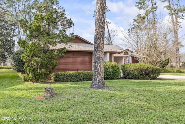 view of home's exterior with a yard