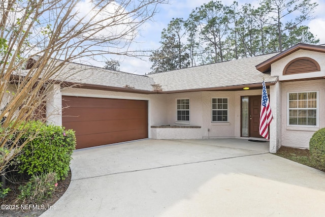 ranch-style home with a shingled roof, driveway, a garage, and stucco siding