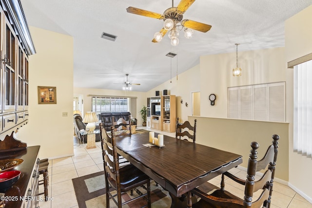 dining room featuring light tile patterned floors, ceiling fan, lofted ceiling, visible vents, and baseboards