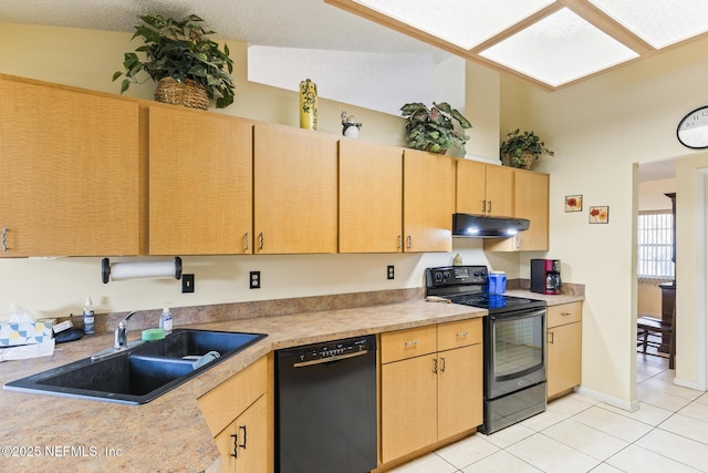 kitchen with light tile patterned floors, light countertops, a sink, under cabinet range hood, and black appliances