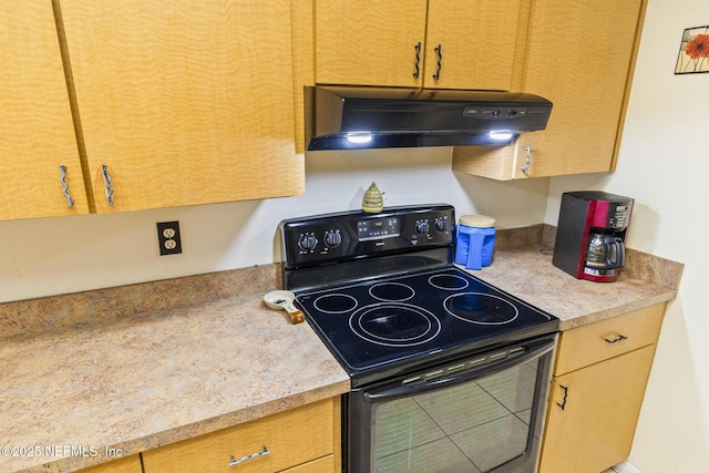 kitchen featuring under cabinet range hood, light countertops, and black electric range oven