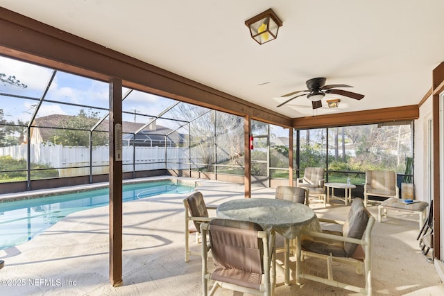 exterior space featuring a fenced in pool, glass enclosure, fence, and ceiling fan