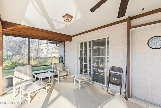 sunroom / solarium featuring ceiling fan