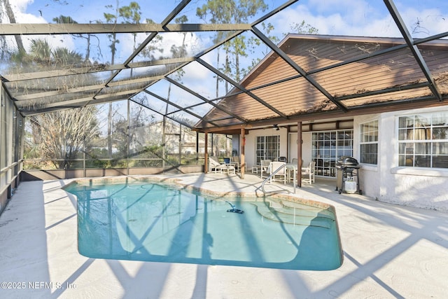 pool featuring a patio, a grill, glass enclosure, and a ceiling fan