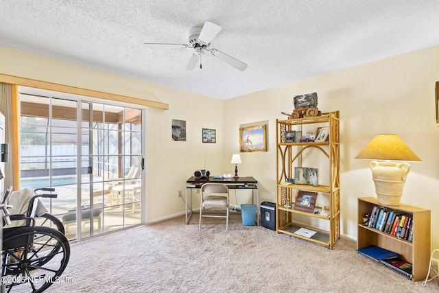 office featuring baseboards, a textured ceiling, a ceiling fan, and carpet flooring