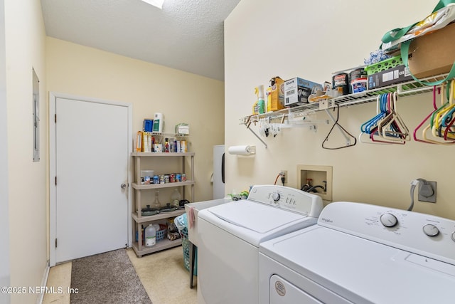 washroom featuring a textured ceiling, laundry area, and separate washer and dryer