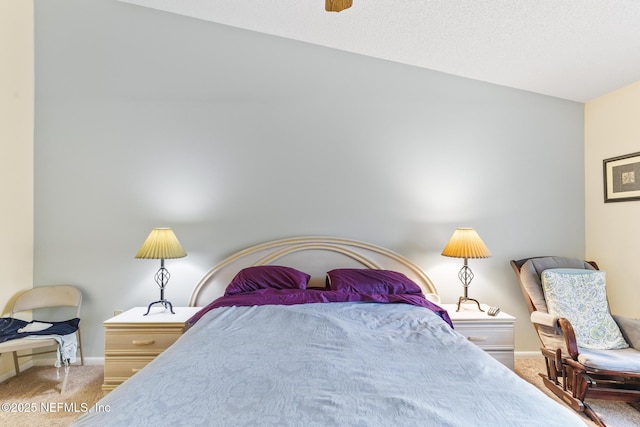 carpeted bedroom with ceiling fan and baseboards