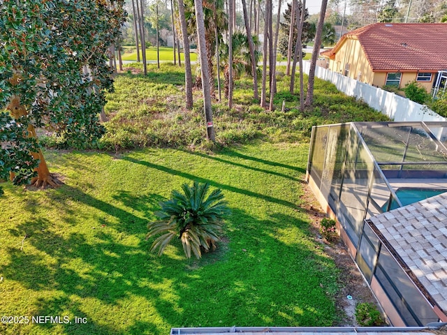 view of yard featuring a fenced in pool and fence