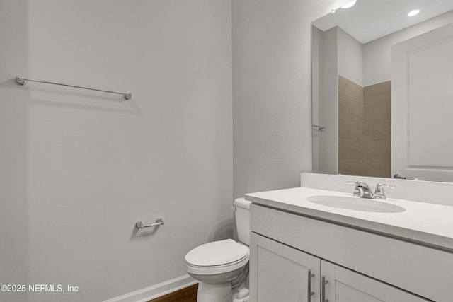 4484 Sun Garden Dr, Jacksonville, FL 32257 - bathroom featuring baseboards, toilet, wood finished floors, and vanity