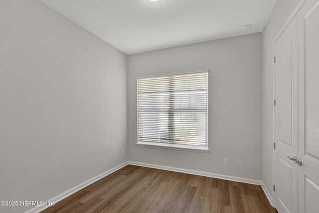 4484 Sun Garden Dr, Jacksonville, FL 32257 - unfurnished room with baseboards and wood finished floors