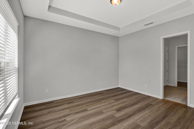 4484 Sun Garden Dr, Jacksonville, FL 32257 - spare room featuring visible vents, dark wood-style floors, and baseboards