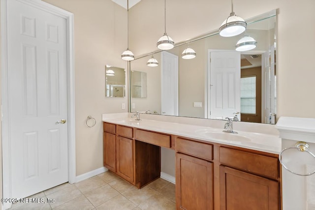 bathroom featuring tile patterned floors, visible vents, double vanity, and a sink