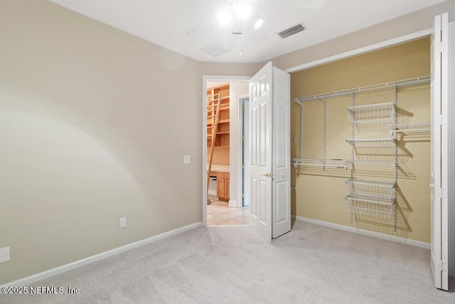 unfurnished bedroom with visible vents, baseboards, carpet, a closet, and a ceiling fan