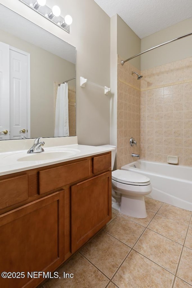 bathroom featuring vanity, shower / bathtub combination with curtain, tile patterned flooring, a textured ceiling, and toilet