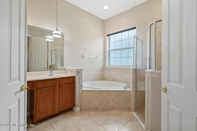 bathroom with tile patterned floors, a stall shower, a bath, and vanity