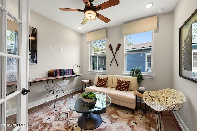 living area featuring a ceiling fan, recessed lighting, wood finished floors, and baseboards