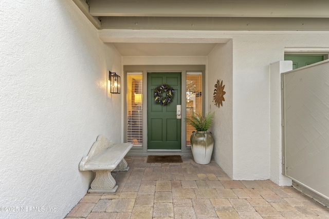 doorway to property with stucco siding