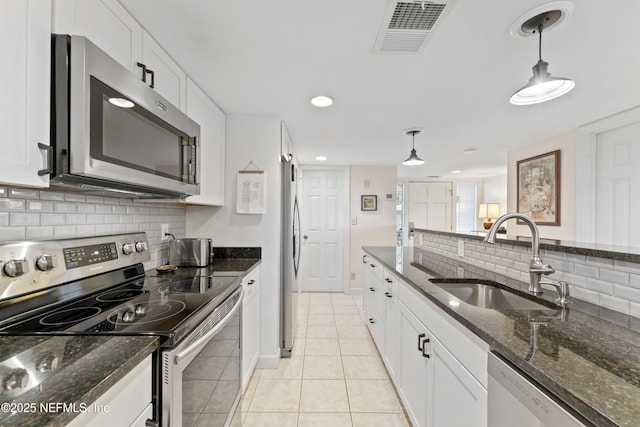 kitchen featuring a sink, white cabinets, visible vents, and stainless steel appliances