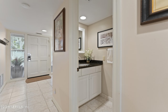 bathroom with tile patterned flooring, recessed lighting, vanity, and baseboards