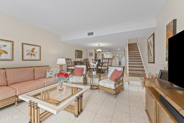 living room with light tile patterned floors, visible vents, ornamental molding, and stairway