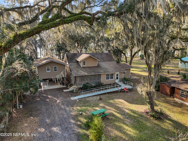 exterior space featuring a front yard, fence, and stairs