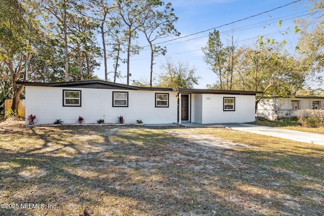 ranch-style home featuring a front yard