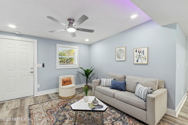 living room featuring recessed lighting, wood finished floors, and baseboards