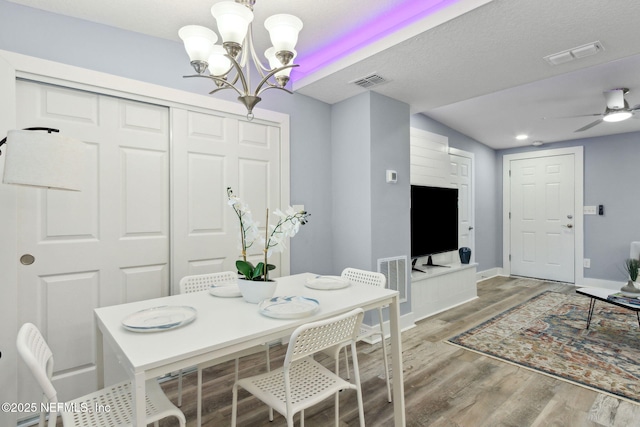 dining area with visible vents, baseboards, and wood finished floors