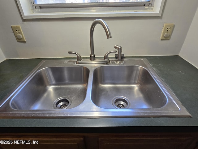 room details featuring dark countertops and a sink