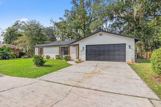 ranch-style house with a garage, concrete driveway, fence, a front lawn, and stucco siding