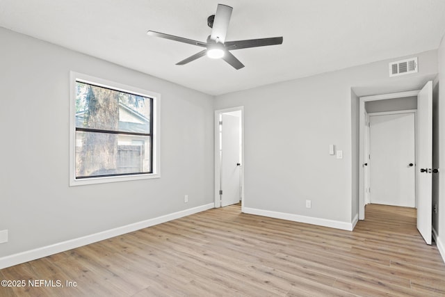 unfurnished bedroom featuring light wood finished floors, baseboards, visible vents, and a ceiling fan