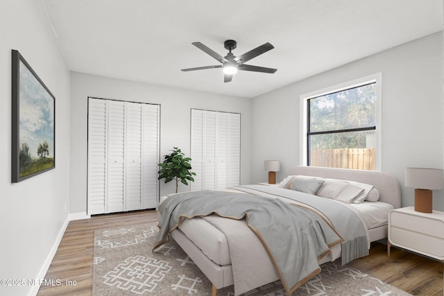 bedroom featuring ceiling fan, baseboards, and wood finished floors