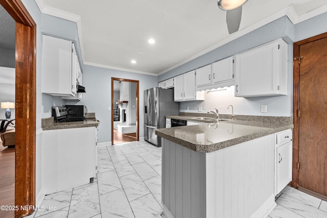 kitchen with a sink, white cabinetry, marble finish floor, ornamental molding, and stainless steel fridge