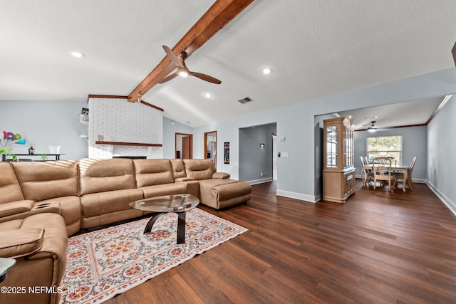 living area featuring visible vents, dark wood finished floors, lofted ceiling with beams, ceiling fan, and a textured ceiling