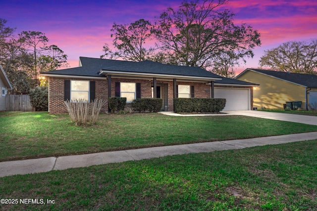 single story home featuring a yard, driveway, an attached garage, and fence